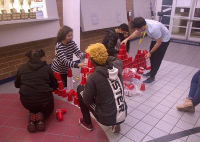 team working together to stack cups